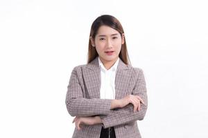 Asian confident woman in formal suit is standing and arm crossing with smiling face on white background. photo