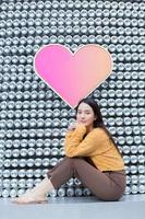 Asian beautiful woman with long hair is sitting and smiling in heart background as Valentine s day concept. abstract background photo