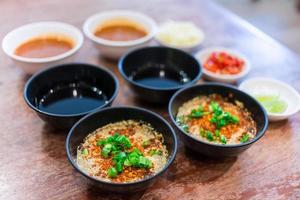 Suki Sauce is a chili sauce suki asia style food. Jaew Dipping sauce as Thai spicy dipping sauce  and Ponzu sauce are served with fresh chopped chili and minced garlic in Sukiyaki, Shabu restaurant. photo