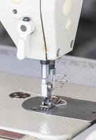 Close up industrial sewing machine photo