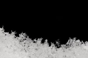 delicate snow and black background photo