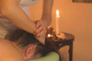 close up of massage process. Woman hands do massage in spa. photo