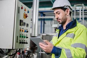 technician engineer working to maintenance a construction equipment industry, production technology in plant factory, man working to safety control system in manufacturing product factory photo