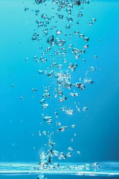 Abstract background image of bubbles in water. Clean water with water droplets and waves. Fresh water a glass with bubbles blue background. photo