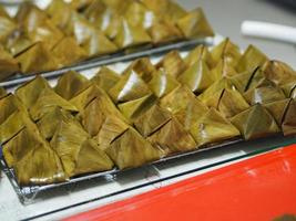 Stuffed Dough Pyramid Dessert Stuffed Dough Pyramid, year cake, Chinese New Year cake, dessert Made with glutinous rice flour and sugar put banana leave small basket and steamed cooked photo