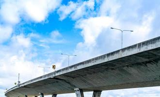 Bottom view of elevated concrete highway. Overpass concrete road. Road flyover structure. Modern motorway. Transportation infrastructure. Concrete bridge engineering construction. Bridge architecture. photo