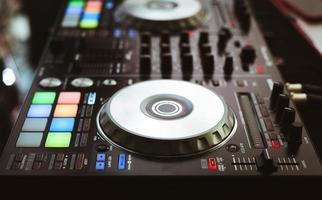 DJ plays and mix music on digital midi controller photo