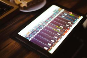 Mixing music on tablet with electronic music instruments concept photo