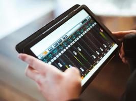 Mixing music on tablet with electronic music instruments concept photo