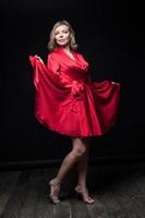 Sexy blonde in red dress in Studio photo