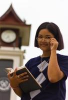 Teen reading clock tower. photo