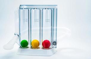 Device for exercising respiration through deep inspiration triple chamber. Medical equipment for respiratory therapy after surgery. Deep Breathing lung exerciser. Breath Measurement. 3 color balls. photo