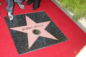 LOS ANGELES, SEP 7 - Buddy Holly Star, with Gary Buseys feet at the Buddy Holly Walk of Fame Ceremony at the Hollywood Walk of Fame on September 7, 2011 in Los Angeles, CA photo