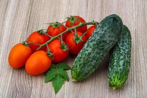 Cucumbers and tomatoes on the branch photo