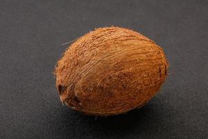 Tropical brown coconut over background photo