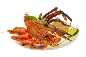 Spiny lobster, shrimps, crab legs  and rice photo