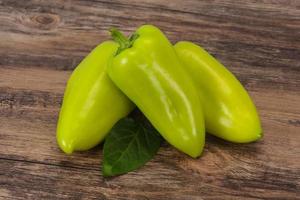 Green bell pepper over wooden background photo