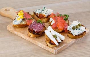 Tapas with cheese, salami and salmon photo