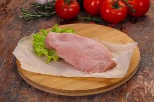 Raw Turkey steak served rosemary photo