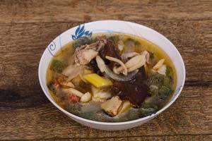 Thai style soup with meat and mushrooms photo