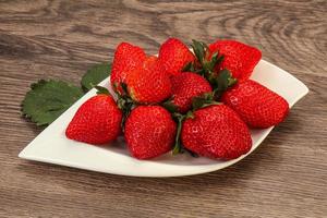 Ripe sweet strawberry with leaf photo