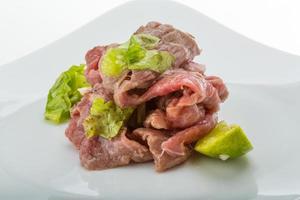 Beef carpaccio on white background photo