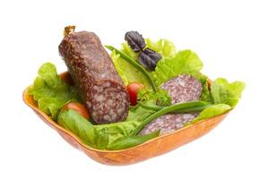 Ripe salami with salad, basil, onion and tomato photo