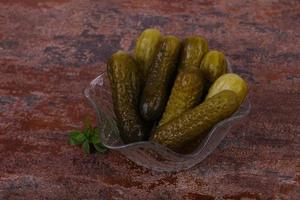 Pickled cucumbers heap in the bowl photo