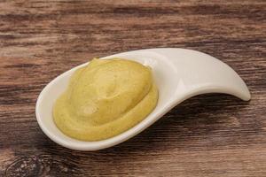 Dijon mustard sauce in the bowl photo