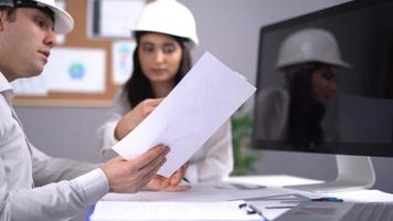 Engineers working on the project. Two engineers are working on the project at the desk. video