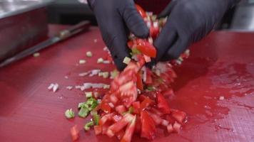 The cook preparing the salad. The cook preparing the salad is mixing it with his hand. video