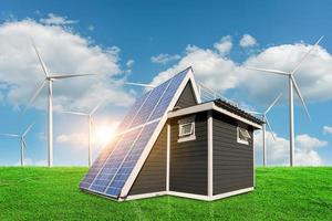 Solar panels on a house roof on green grass with wind turbine and blue sky background. alternative electricity source - sustainable resources concept. photo