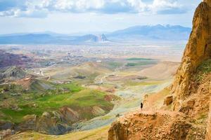 Female solo traveler look over dramatic valley. Solo exploration in Turkey. Cinematic Travel destination-Cappadocia 2020. photo