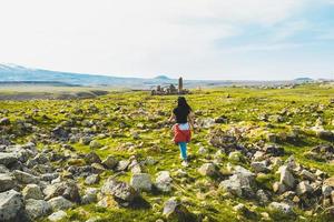 Caucasian female tourist walk around Ani ruins sightseeing in spring. Travel destination in Kars photo