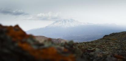 Snowy mountain ararat peak with cloud pass from Turkey side in late spring. At the foot of mt Ararat photo