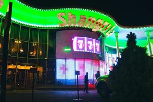 Tbilisi, Georgia, 2022 - famous Shangri La classic casino house building with ads billboards display and parked cars photo