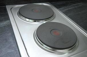 Electric steel stove on black counter top photo