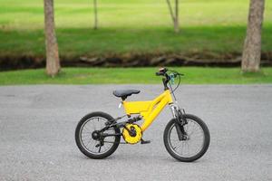 Yellow bicycle park on street in the park photo