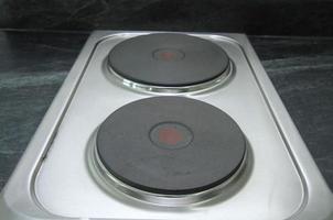 Electric steel stove on black counter top photo