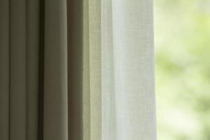 Curtain with window view from green tree background photo