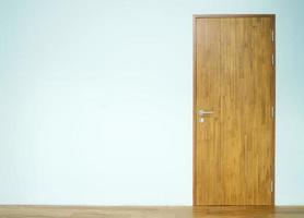 Wooden door with blue wall photo