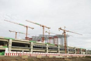 Large construction site with tower crane and blue sky photo