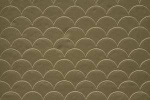 Brown fish scale seamless pattern on decorated cement wall photo