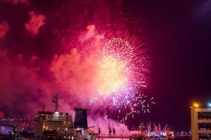 Fireworks over the bay and port of the city. Vladivostok, Russia photo