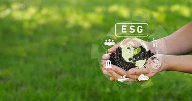 Mobile planting trees ESG icon concept circulating in hand for environment, society and governance SG in sustainable business Use renewable resource technology to reduce pollution.
