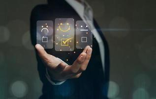A business woman uses a customer rating service. In the service experience on the online application, the rating evaluates the concept of customer feedback. with rating icon photo
