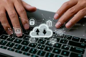 A cloud computing diagram is displayed on a laptop in the hands of a man. Networking and internet service principles for data storage in the cloud. photo