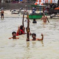 Garh Mukteshwar, Uttar Pradesh, India - June 11 2022 - People are taking holy dip on the occasion of Nirjala Ekadashi, A view of Garh Ganga ghat which is very famous religious place for Hindus photo