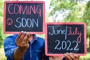 Indian couple posing for maternity baby shoot. The couple is posing in a lawn with green grass and the woman is falunting her baby bump in Lodhi Garden in New Delhi, India photo