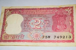 Old Two Rupee notes combined on the table, India money on the rotating table. Old Indian Currency notes on a rotating table, Indian Currency on the table photo